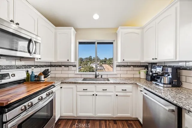 a view of a livingroom with furniture and wooden floor