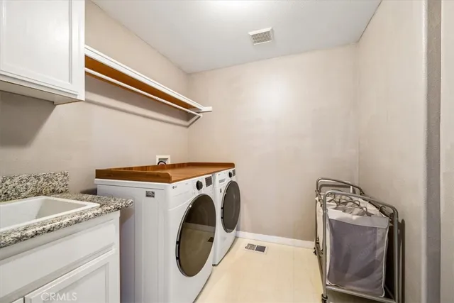 a kitchen with a sink cabinets and window