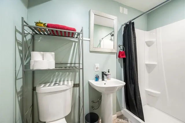 a balcony with couch and potted plants