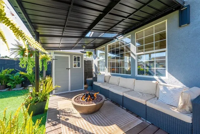 a living room with patio and a potted plant