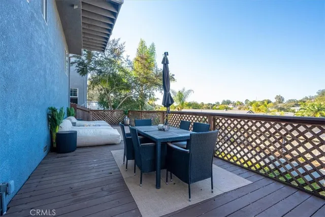a view of a wooden deck and a backyard