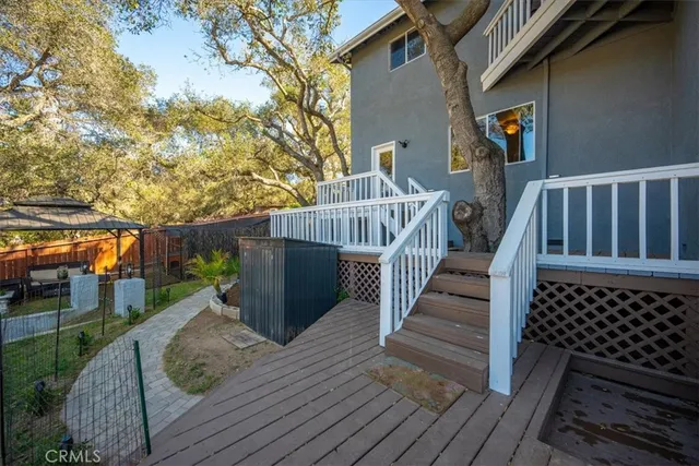 a view of a chairs and table in patio with a yard