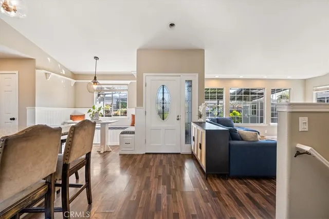 a living room with furniture a flat screen tv and a large window