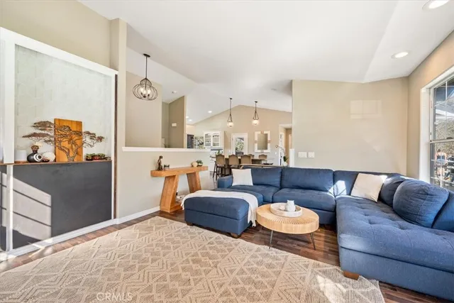 a dining room with stainless steel appliances kitchen island granite countertop a dining table chairs and granite counter tops