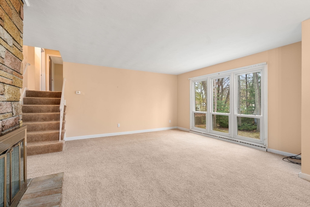 18 Royce Road Framingham, MA 01701 - Photo 12 of 30 an empty room with a exposed radiator down to a window