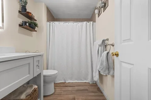 a bathroom with a sink toilet and shower