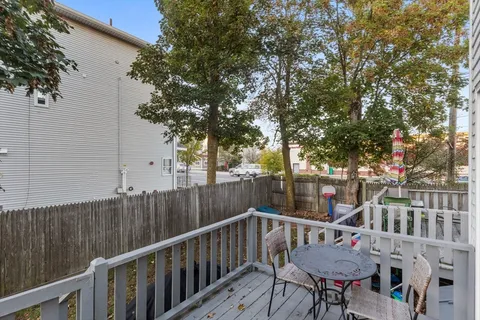 a view of balcony with furniture and trees