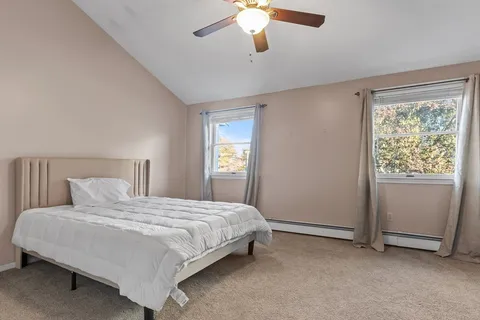 a bedroom with a large bed and a chandelier