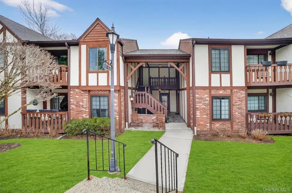 a front view of a house with a garden and plants