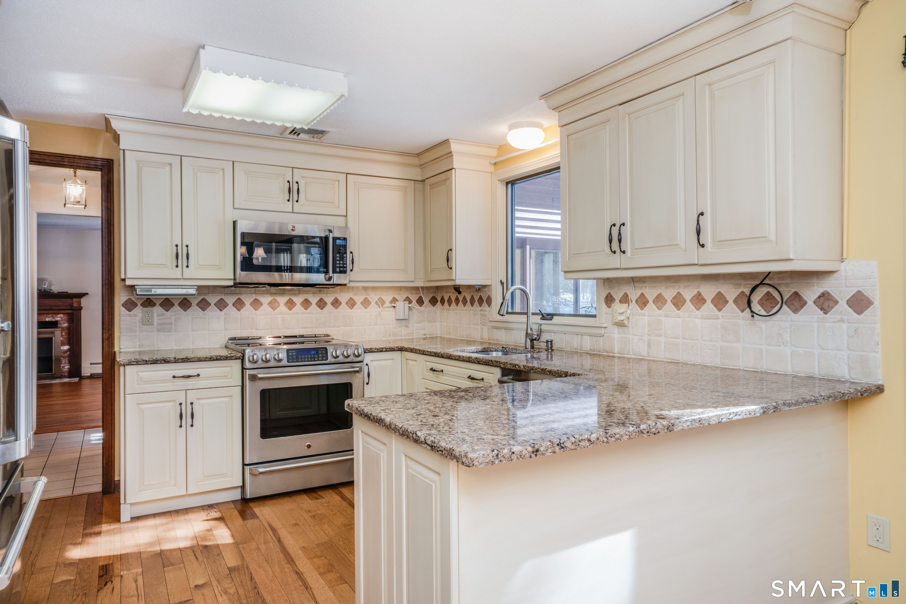 29 Long View Drive Simsbury, CT 06070 - Photo 11 of 41 a kitchen with granite countertop a sink stainless steel appliances and white cabinets