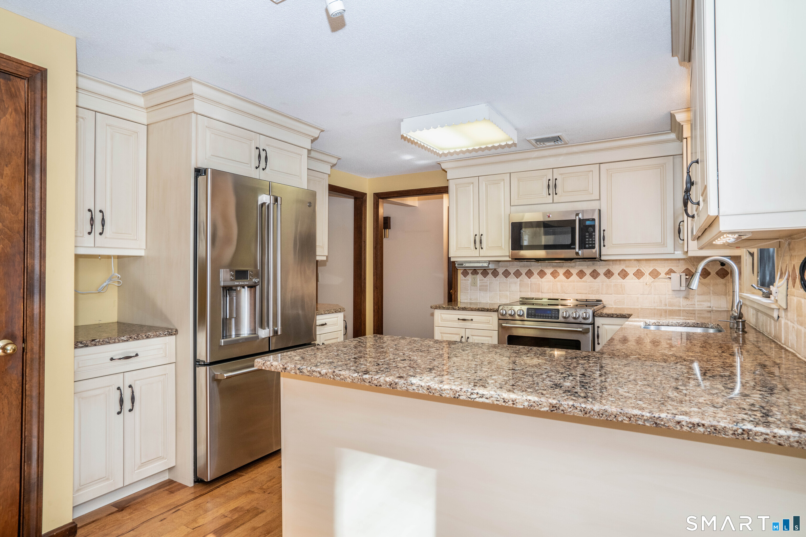 29 Long View Drive Simsbury, CT 06070 - Photo 13 of 41 a kitchen with granite countertop a refrigerator and a sink