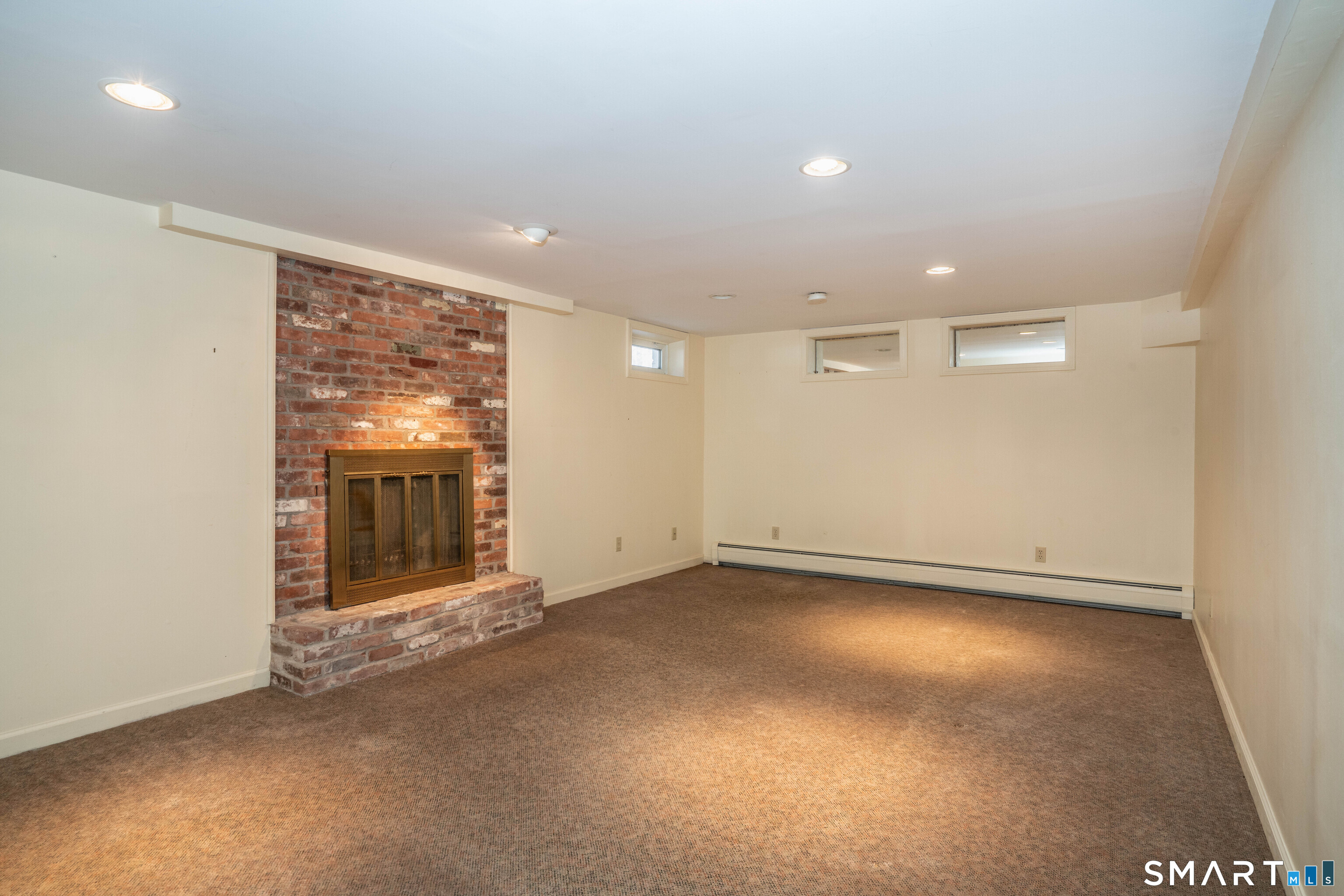 29 Long View Drive Simsbury, CT 06070 - Photo 34 of 41 an empty room with a fireplace and large window