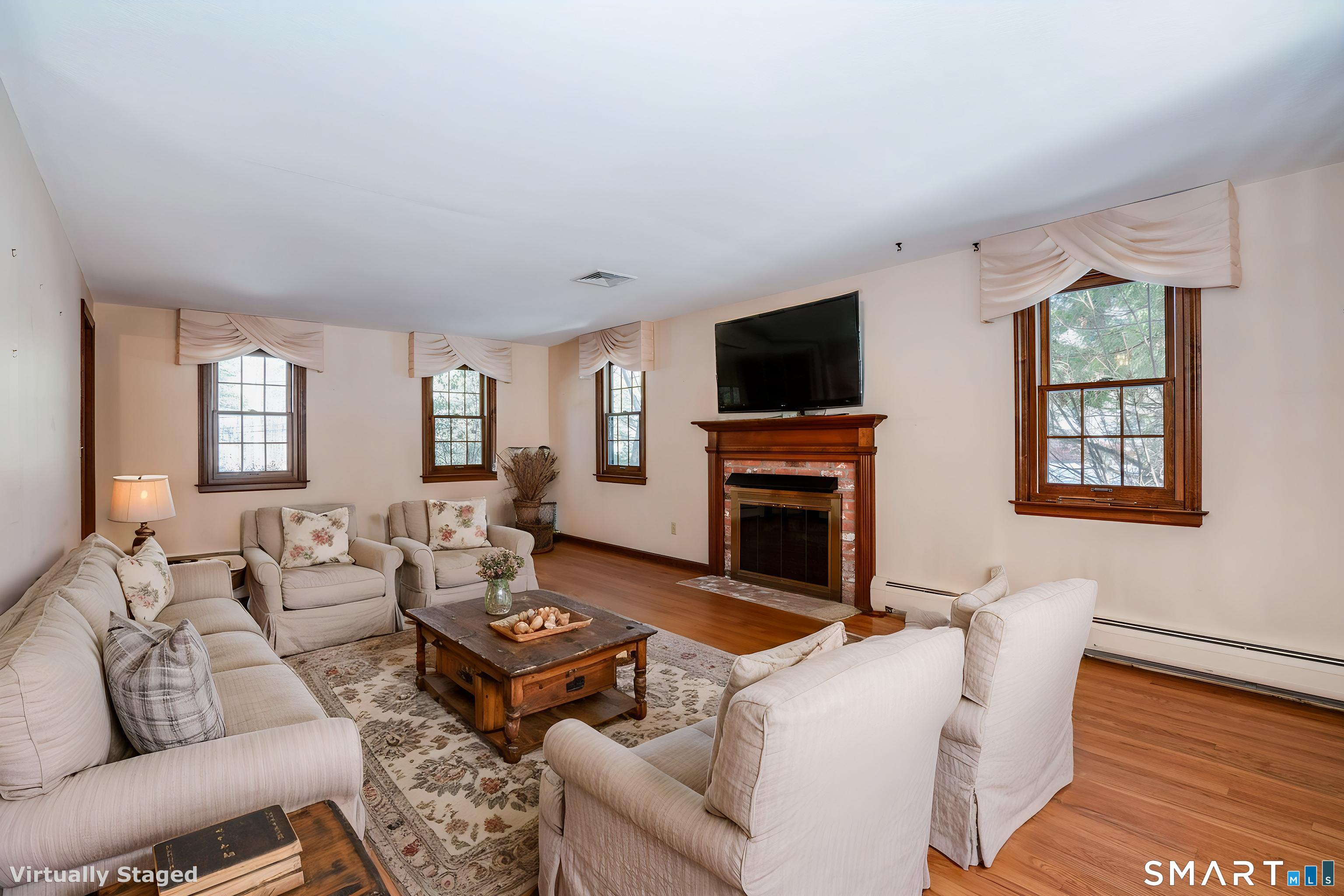 29 Long View Drive Simsbury, CT 06070 - Photo 5 of 41 a living room with furniture a fireplace and a flat screen tv