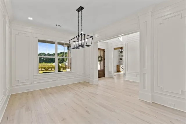 a kitchen with white cabinets and sink