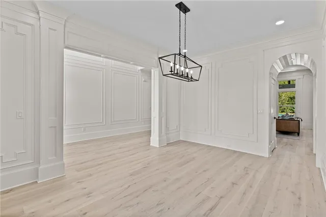 a large kitchen with stainless steel appliances kitchen island granite countertop a large counter top a sink a stove and a wooden floors