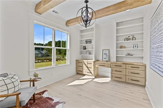 a large white kitchen with a large counter top appliances and cabinets