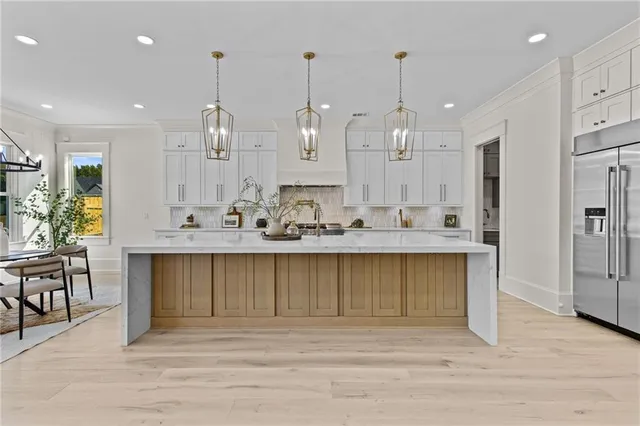 a spacious bathroom with a granite countertop sink a large mirror a shower and a bathtub