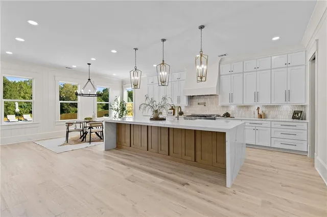 a view of a hallway with wooden floor and entryway
