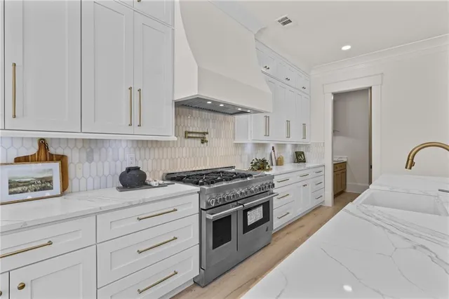 a bedroom with a bed and potted plants with the wooden floor