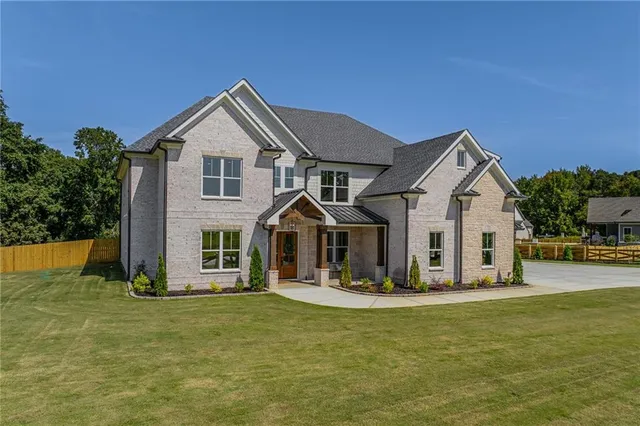 a front view of a house with a yard