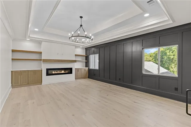 an aerial view of a residential houses with outdoor space and trees