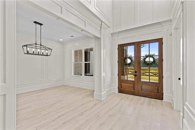 a living room with furniture a fireplace and a chandelier