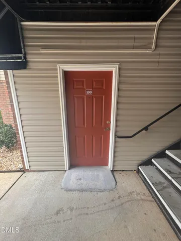 a view of a hallway with wooden cabinets