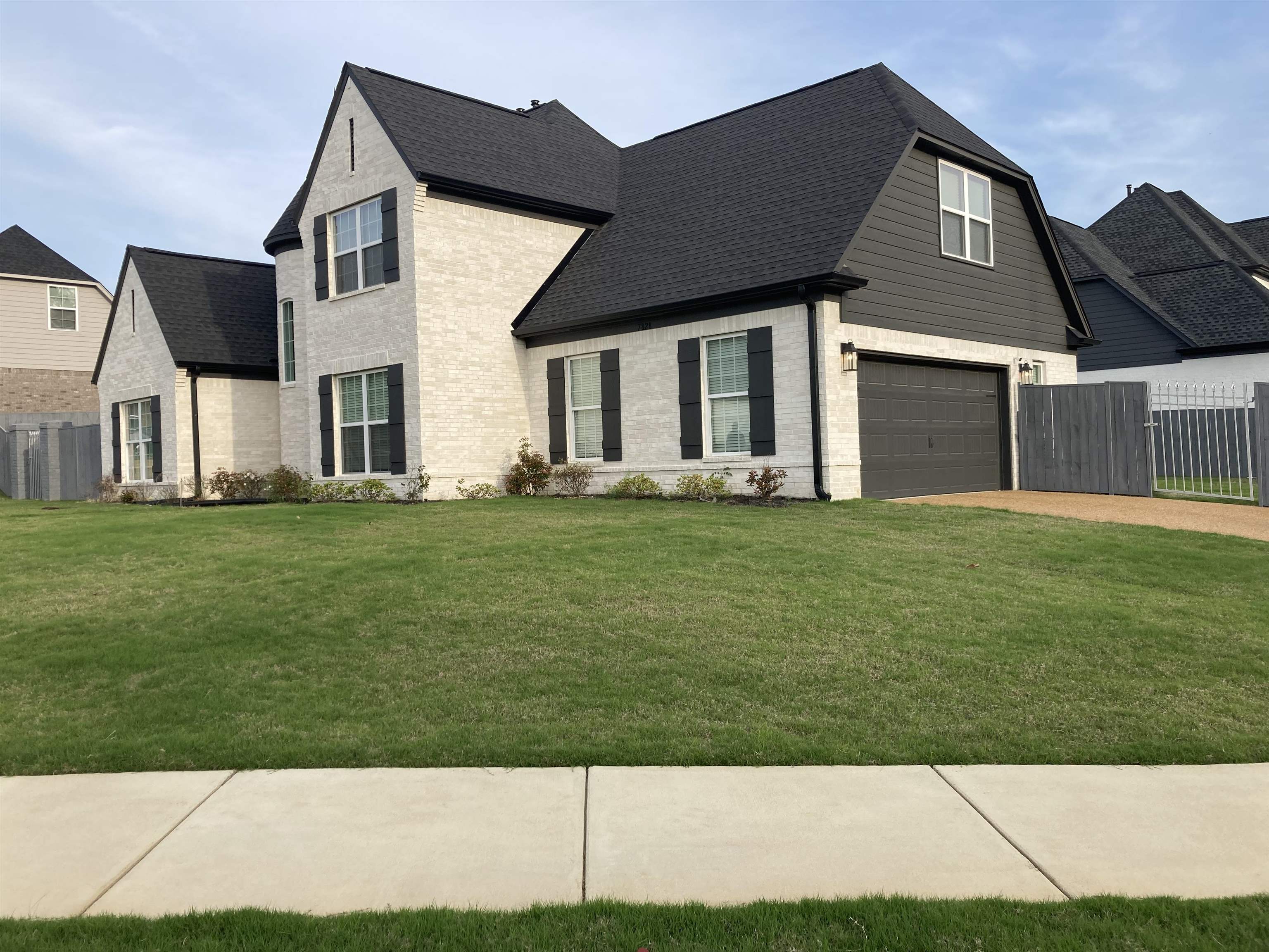 7828 Shadowcrest Road Memphis, TN 38125 - Photo 1 of 13 a front view of a house with a yard