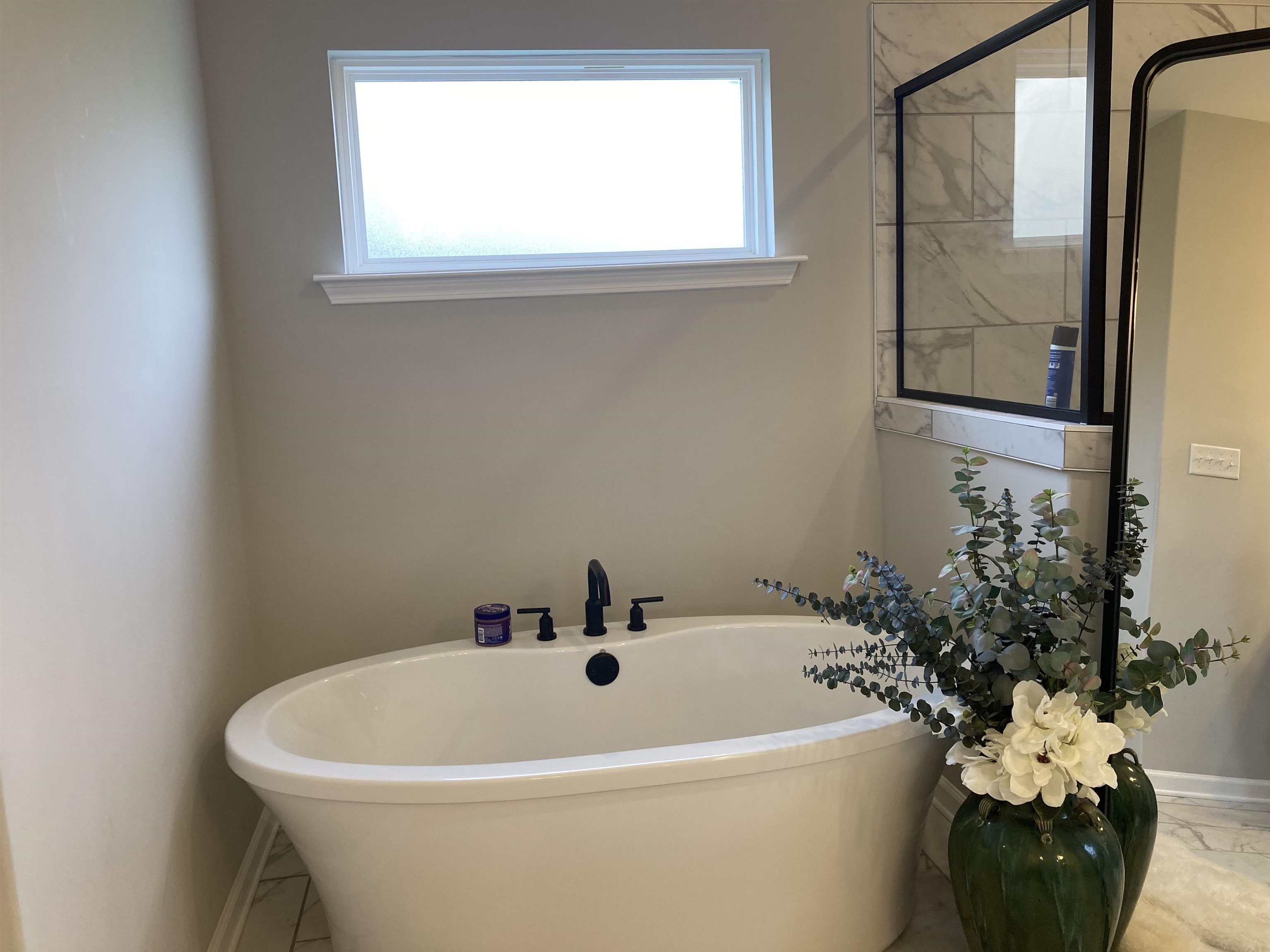 7828 Shadowcrest Road Memphis, TN 38125 - Photo 11 of 13 a white bath tub sitting in a bathroom