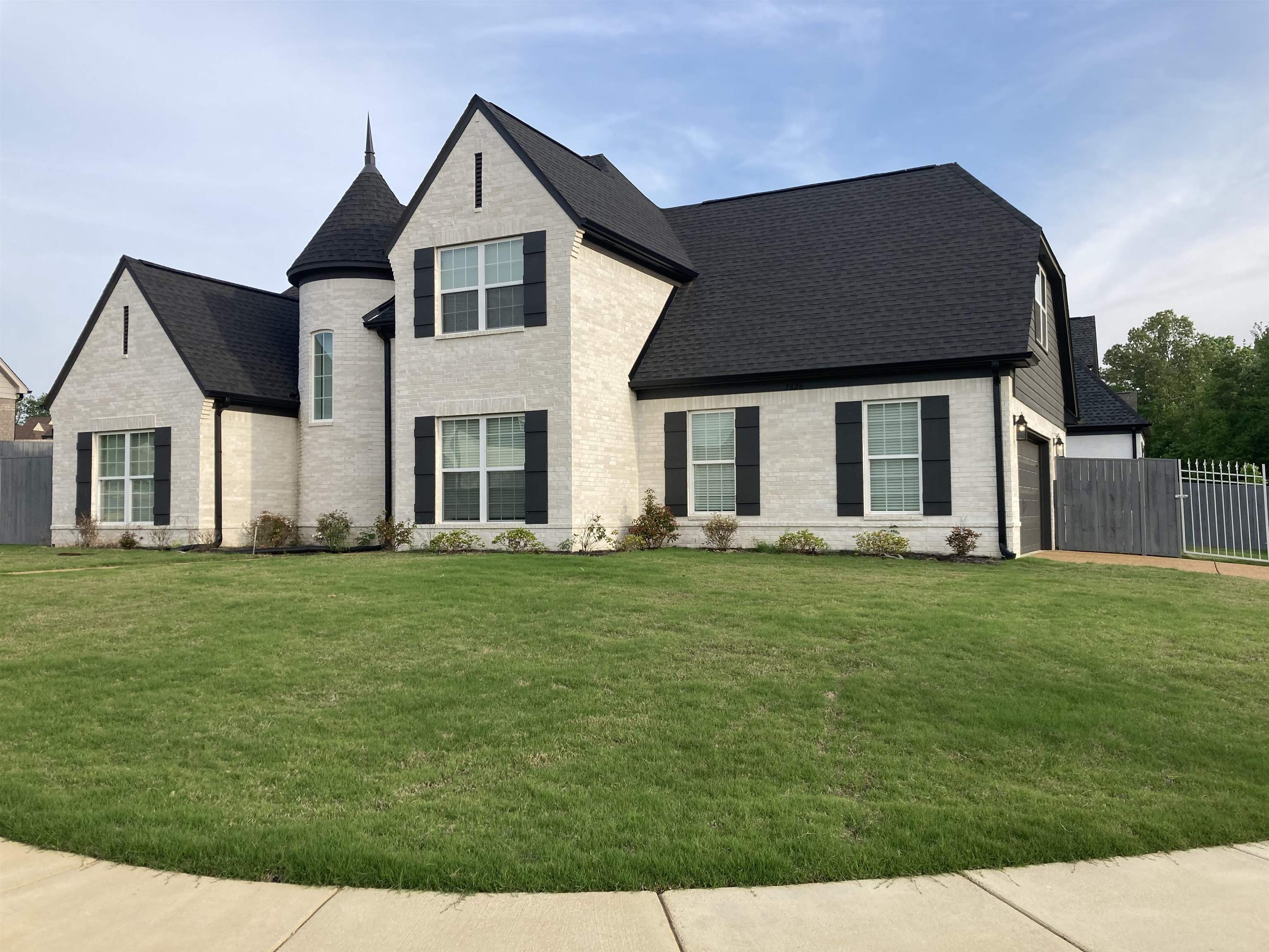 7828 Shadowcrest Road Memphis, TN 38125 - Photo 2 of 13 a front view of a house with a garden