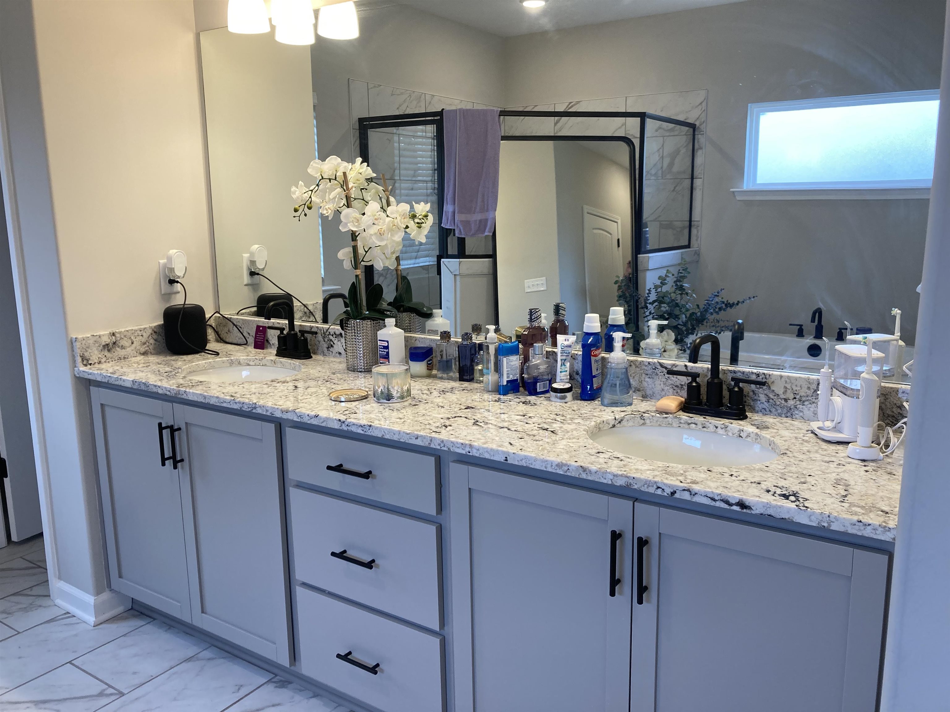 7828 Shadowcrest Road Memphis, TN 38125 - Photo 10 of 13 a bathroom with a granite countertop sink and a mirror