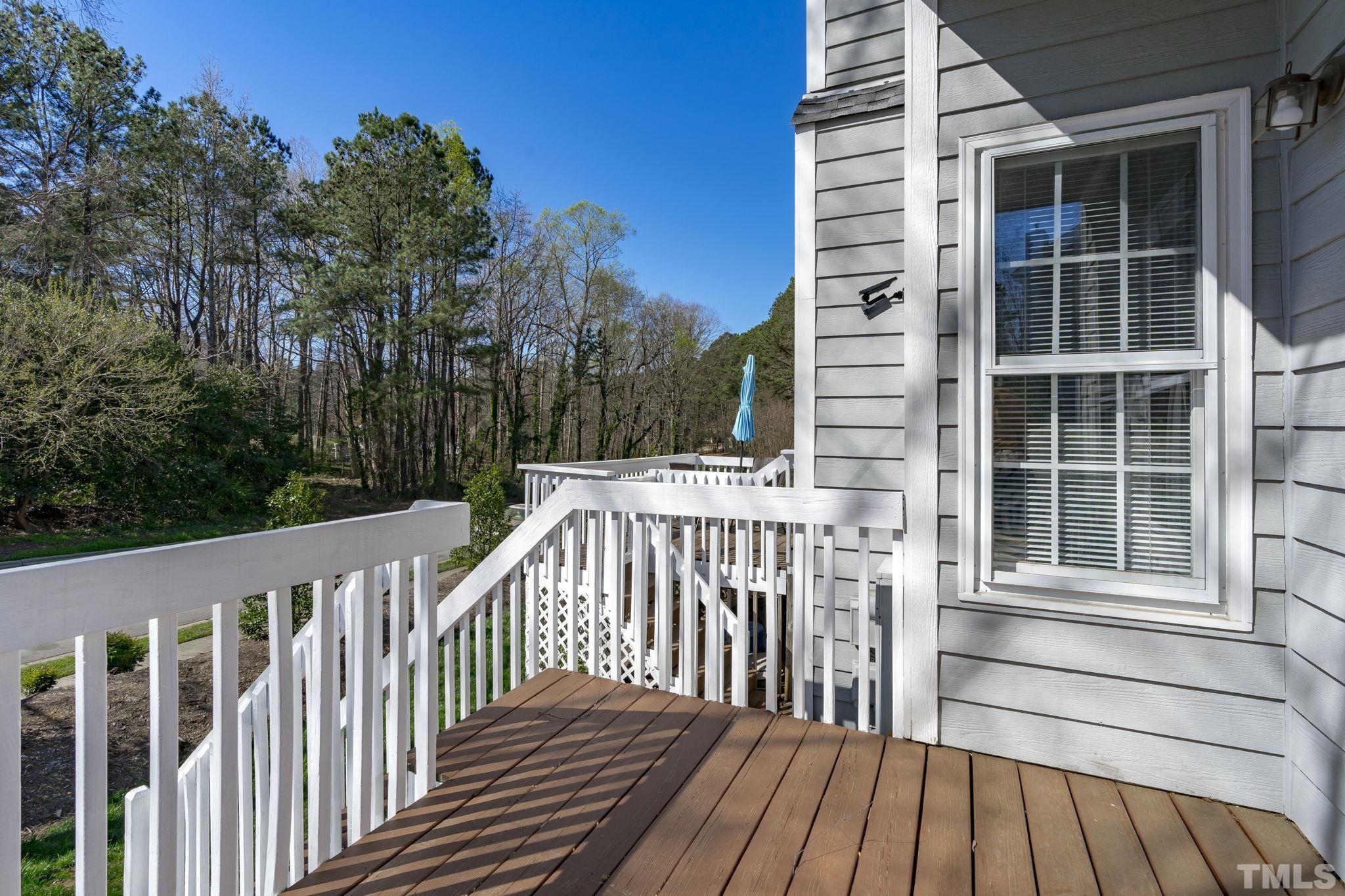 8201 Hempshire Place, Unit 101 Raleigh, NC 27613 - Photo 13 of 15 a view of a wooden balcony and trees
