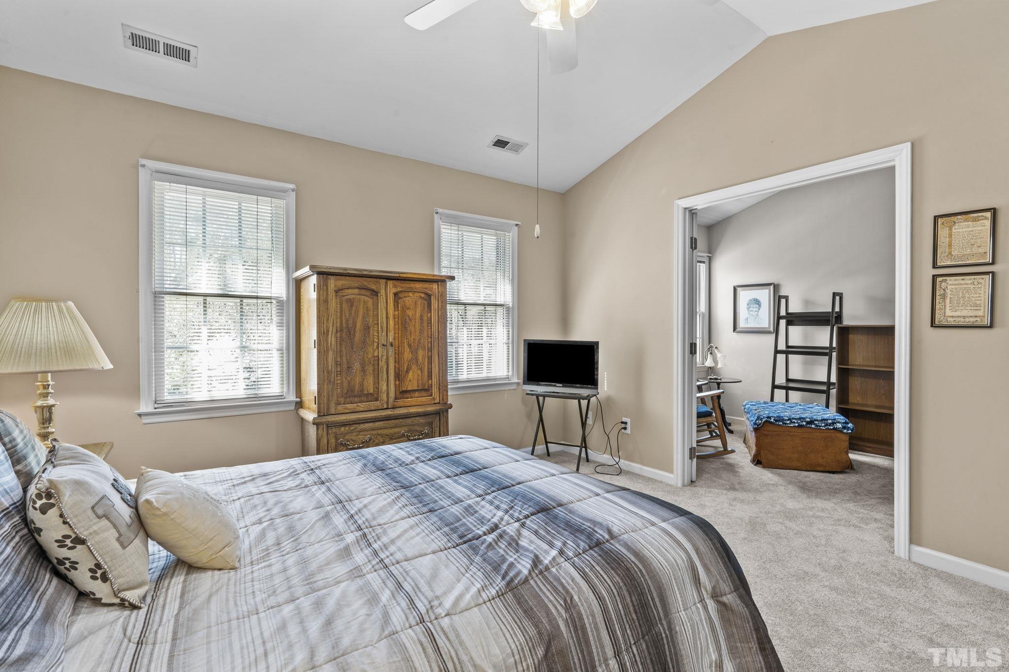 8201 Hempshire Place, Unit 101 Raleigh, NC 27613 - Photo 9 of 15 a bedroom with a bed and a view of kitchen