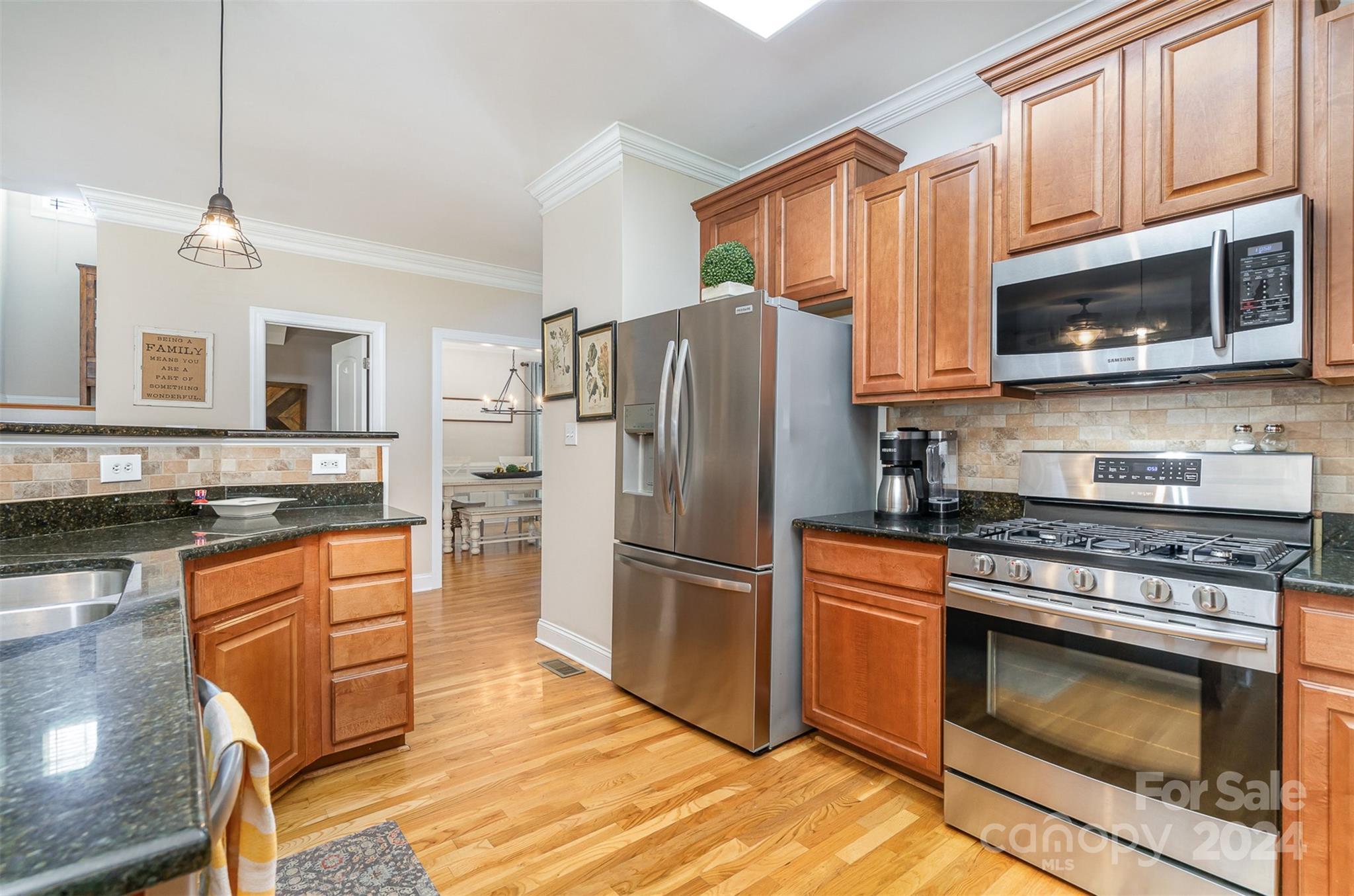 334 Adrian Road Salisbury, NC 28146 - Photo 14 of 40 a kitchen with stainless steel appliances granite countertop a stove a refrigerator and a microwave