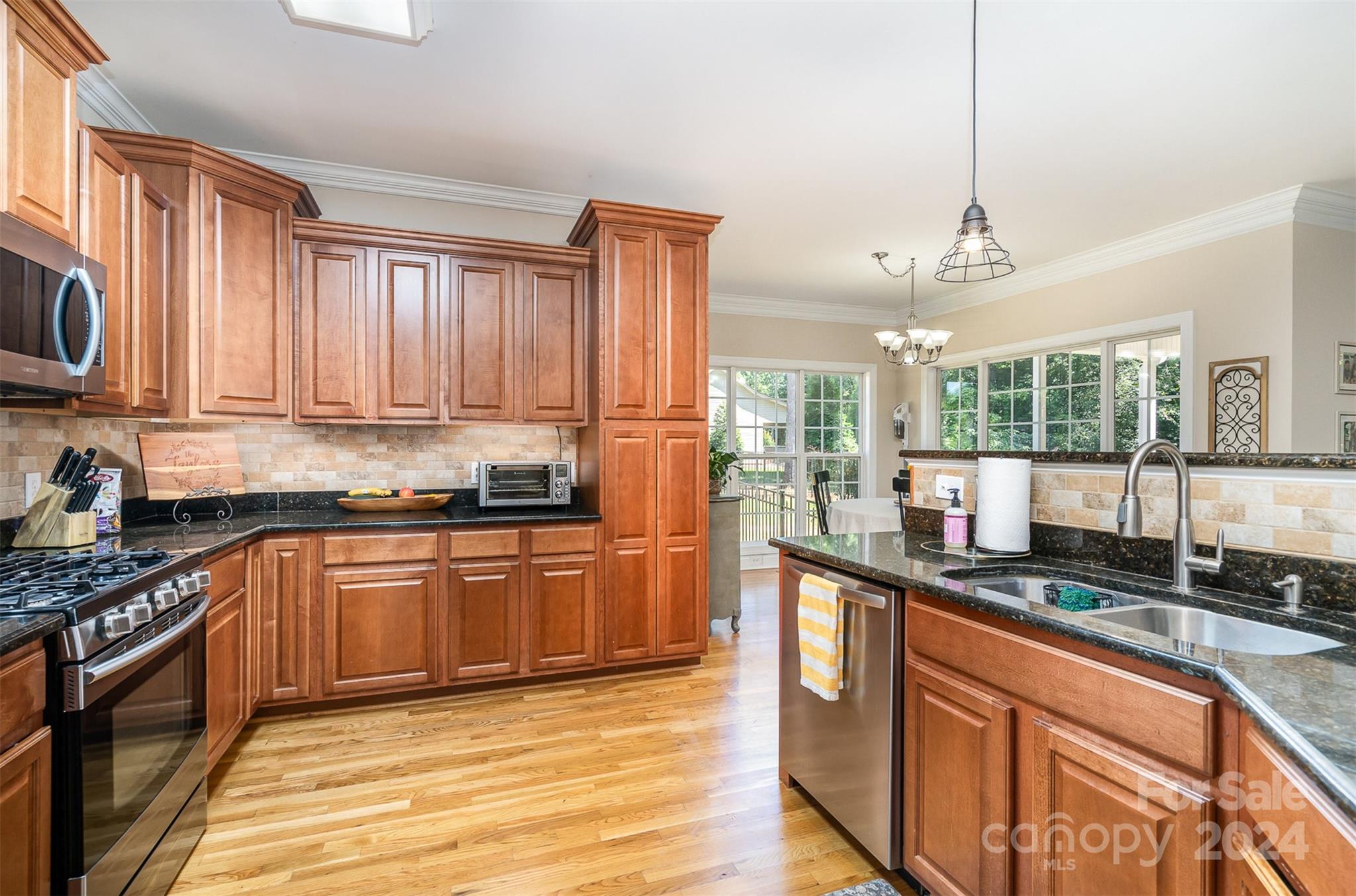 334 Adrian Road Salisbury, NC 28146 - Photo 15 of 40 a kitchen with stainless steel appliances granite countertop a stove a sink and a refrigerator