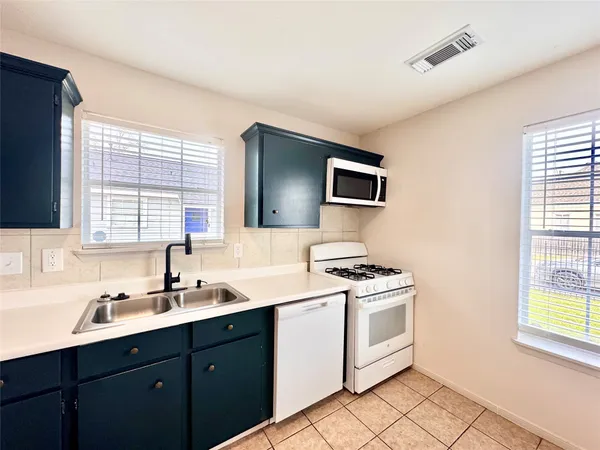 a kitchen with a stove microwave and sink