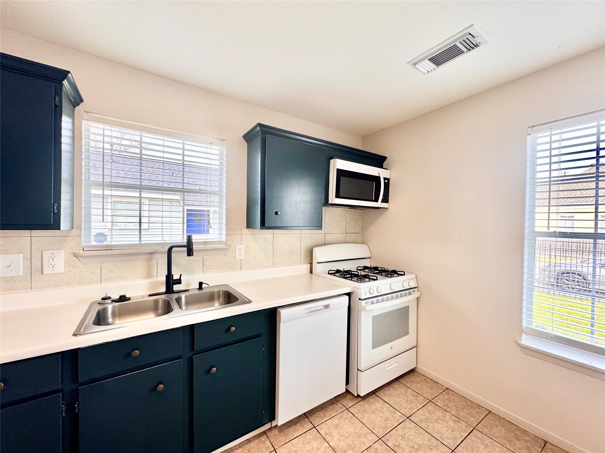 301 Enid Street Houston, TX 77009 - Photo 11 of 34 a kitchen with a stove microwave and sink