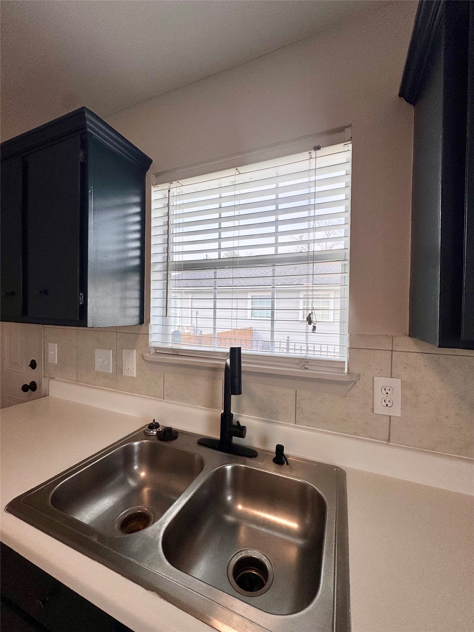 301 Enid Street Houston, TX 77009 - Photo 12 of 34 a kitchen with a sink a stove and cabinets