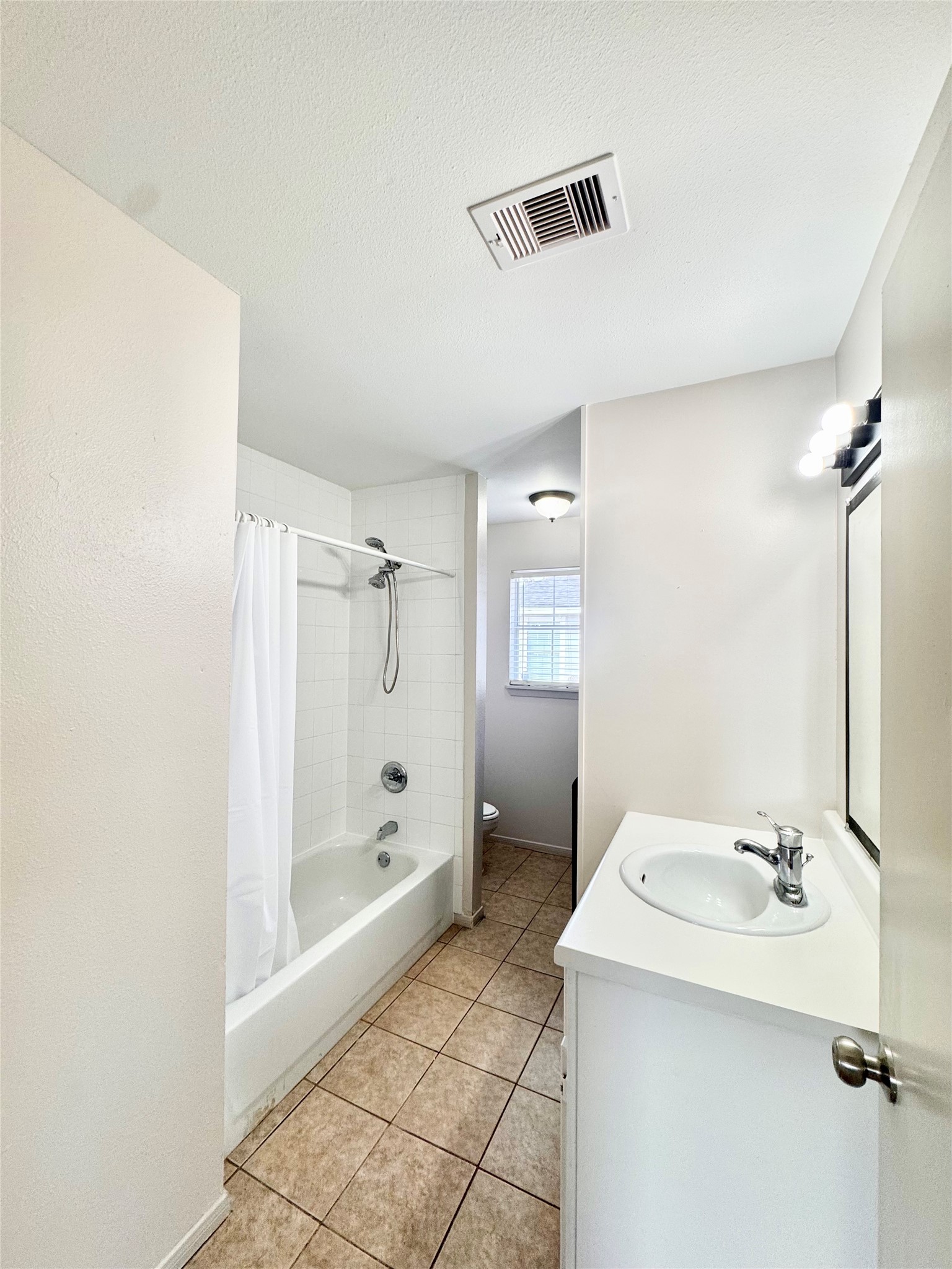 301 Enid Street Houston, TX 77009 - Photo 15 of 34 a bathroom with a sink a toilet and shower
