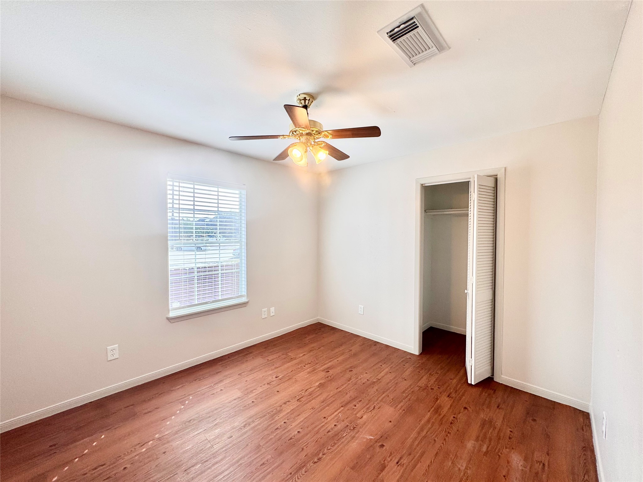 301 Enid Street Houston, TX 77009 - Photo 18 of 34 an empty room with wooden floor and windows