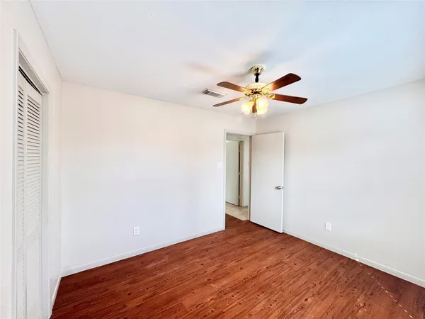 a view of a room with wooden floor