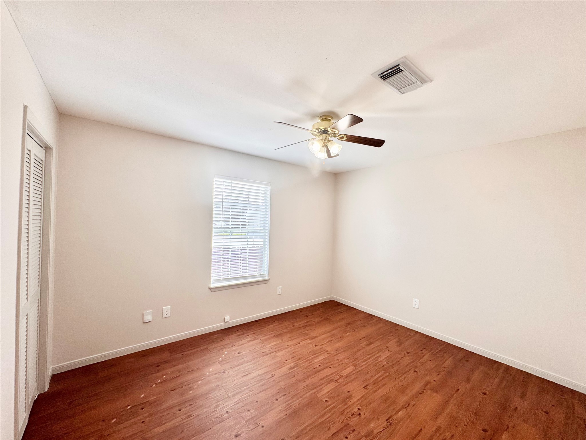 301 Enid Street Houston, TX 77009 - Photo 21 of 34 an empty room with wooden floor and windows