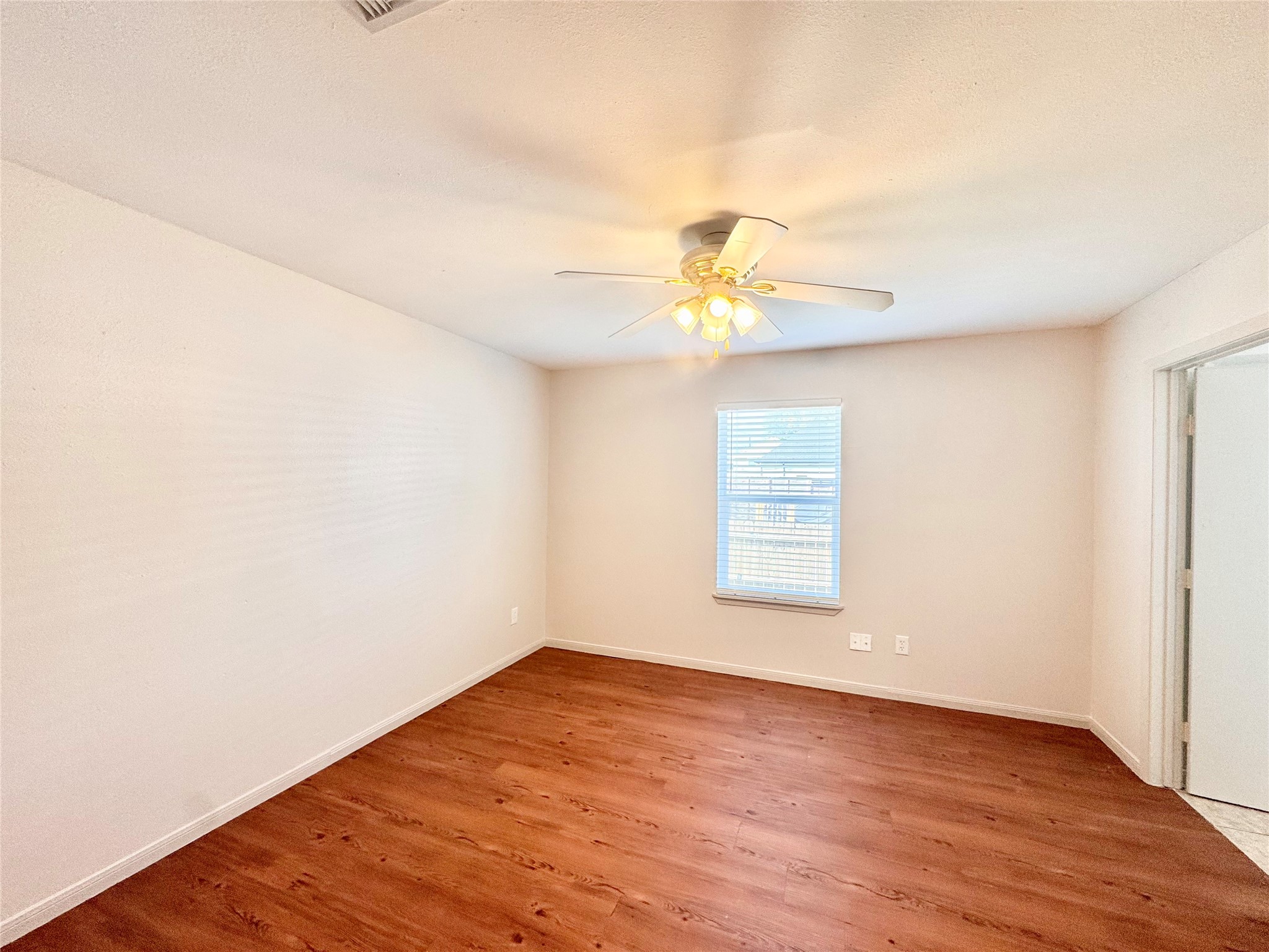 301 Enid Street Houston, TX 77009 - Photo 24 of 34 an empty room with wooden floor and windows