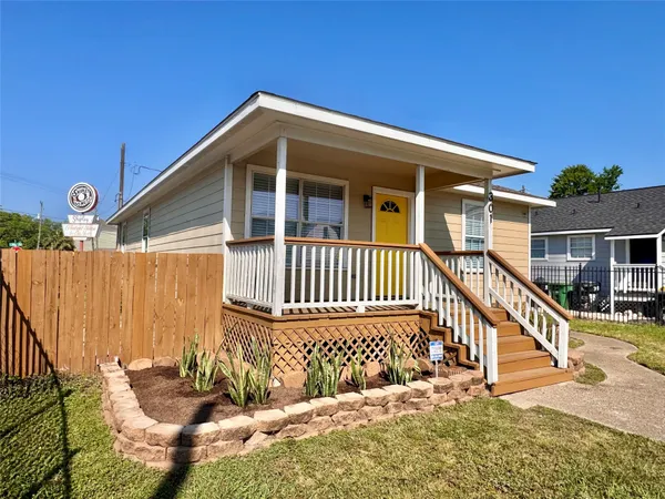 a view of a hallway with wooden floor and a glass door
