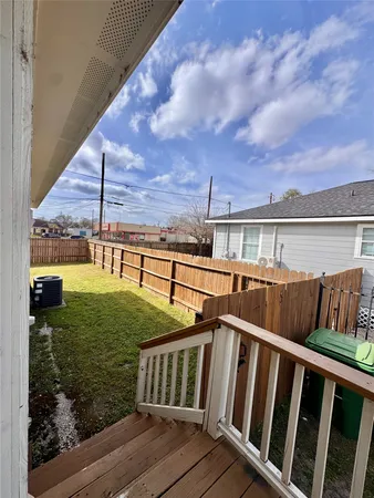 a view of a backyard with wooden fence