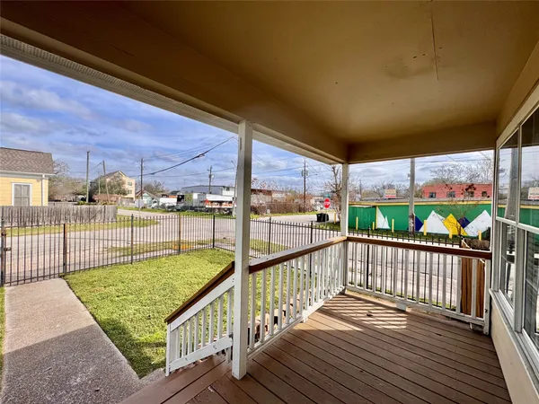 a view of a balcony with wooden floor