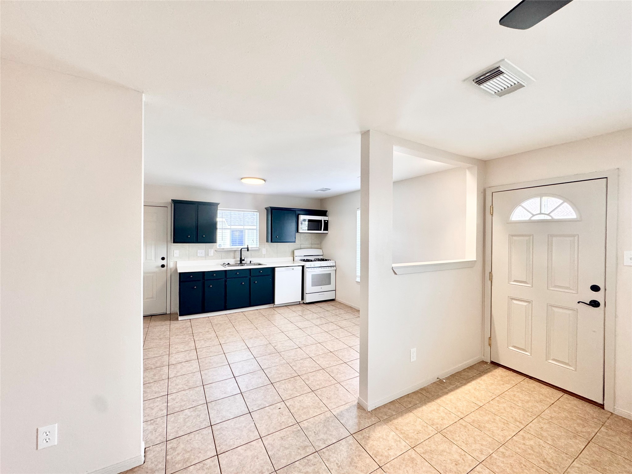 301 Enid Street Houston, TX 77009 - Photo 8 of 34 a large white kitchen with a sink and white cabinets