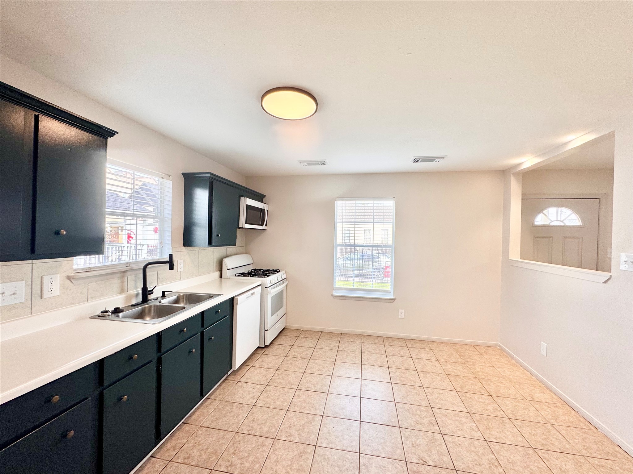 301 Enid Street Houston, TX 77009 - Photo 10 of 34 a spacious bathroom with a granite countertop sink a mirror and a bathtub