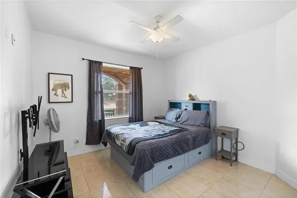 a bedroom with a bed and a painting on the wall