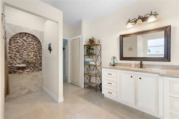 a spacious bathroom with a double vanity sink and a mirror